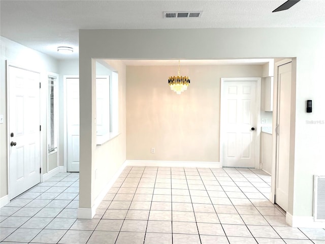 4219 Chateau Rd, Orlando, FL 32808 - foyer with light tile patterned floors and a chandelier