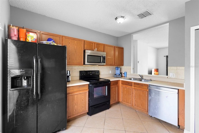 1040 Cannock Dr, Kissimmee, FL 34758 - kitchen with black appliances, light countertops, tasteful backsplash, light tile patterned floors, and a textured ceiling