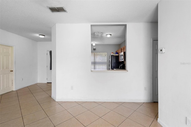 1040 Cannock Dr, Kissimmee, FL 34758 - unfurnished room with a textured ceiling and light tile patterned flooring