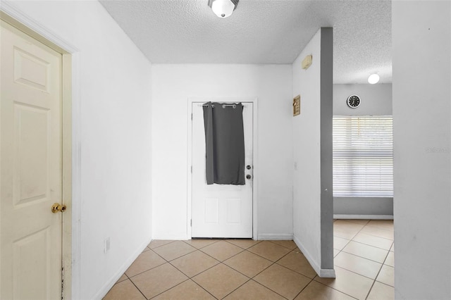 1040 Cannock Dr, Kissimmee, FL 34758 - foyer featuring a textured ceiling and light tile patterned flooring