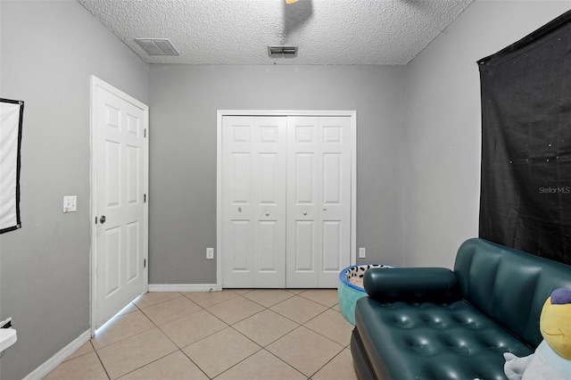 1040 Cannock Dr, Kissimmee, FL 34758 - sitting room with light tile patterned floors and a textured ceiling