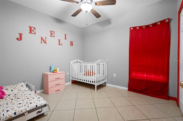 1040 Cannock Dr, Kissimmee, FL 34758 - bedroom with a textured ceiling, light tile patterned flooring, and a ceiling fan