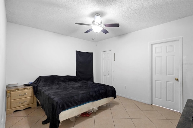 1040 Cannock Dr, Kissimmee, FL 34758 - bedroom featuring light tile patterned floors, a textured ceiling, and a ceiling fan