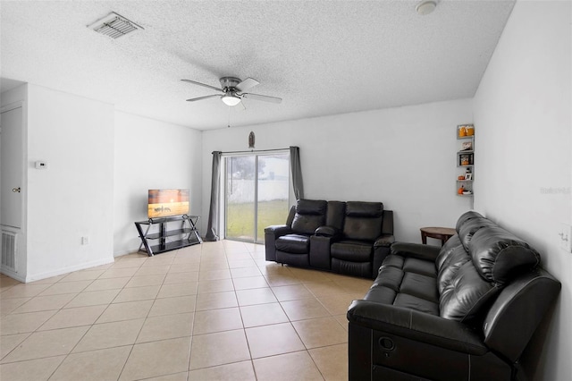 1040 Cannock Dr, Kissimmee, FL 34758 - living area with a ceiling fan, a textured ceiling, and light tile patterned floors