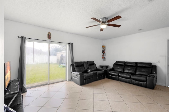 1040 Cannock Dr, Kissimmee, FL 34758 - living room with ceiling fan, a textured ceiling, and light tile patterned flooring