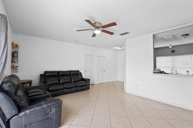 1040 Cannock Dr, Kissimmee, FL 34758 - living area with ceiling fan, light tile patterned flooring, and a textured ceiling