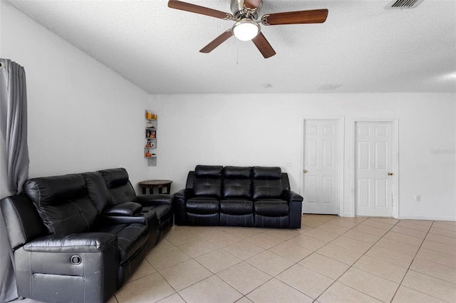1040 Cannock Dr, Kissimmee, FL 34758 - living area with ceiling fan, light tile patterned flooring, and a textured ceiling