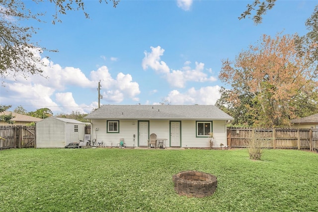 4235 Fay Blvd, Cocoa, FL 32927 - rear view of property with an outdoor fire pit, a fenced backyard, and a storage shed