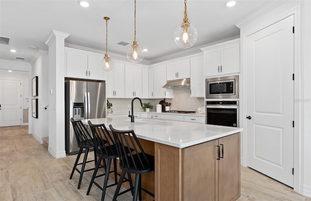 8267 Fenton St, Orlando, FL 32836 - kitchen with appliances with stainless steel finishes, under cabinet range hood, backsplash, light countertops, and ornamental molding