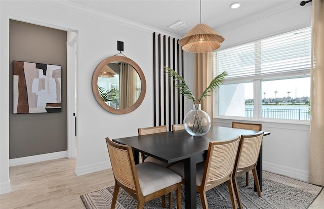 8267 Fenton St, Orlando, FL 32836 - dining area with ornamental molding, light wood finished floors, recessed lighting, and a water view