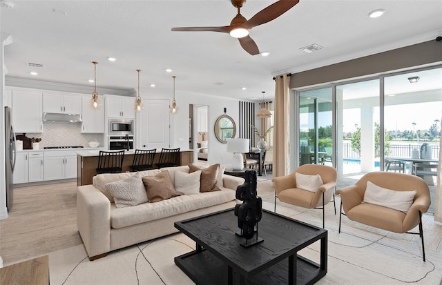 8267 Fenton St, Orlando, FL 32836 - living area featuring ornamental molding, ceiling fan, recessed lighting, and a water view