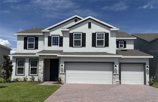 7260 Dilly Lake Ave, Groveland, FL 34736 - view of front of house featuring decorative driveway, stone siding, a garage, and stucco siding