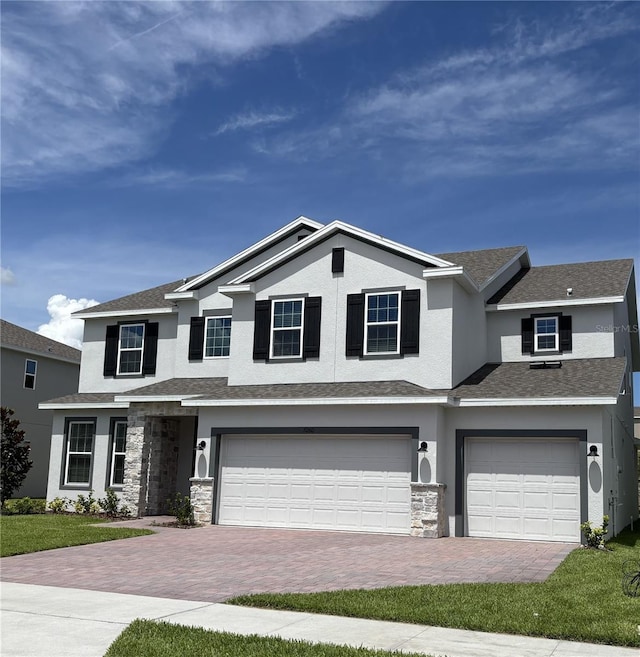 7260 Dilly Lake Ave, Groveland, FL 34736 - view of front of property with a garage, decorative driveway, stucco siding, and stone siding