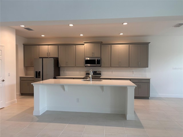 7260 Dilly Lake Ave, Groveland, FL 34736 - kitchen featuring appliances with stainless steel finishes, gray cabinets, backsplash, light countertops, and recessed lighting