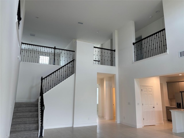 7260 Dilly Lake Ave, Groveland, FL 34736 - staircase featuring a high ceiling and baseboards