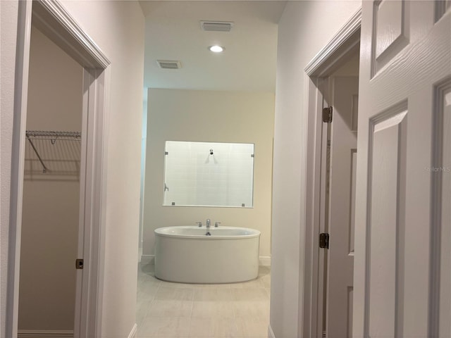7260 Dilly Lake Ave, Groveland, FL 34736 - bathroom with a freestanding tub, a walk in closet, and recessed lighting