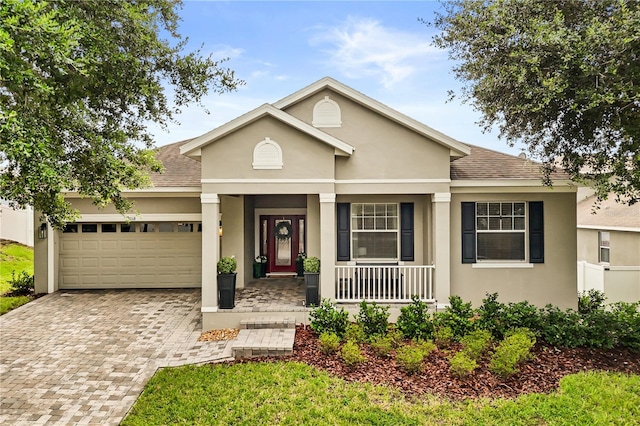2018 Bay Clover Dr, Winter Garden, FL 34787 - view of front of property featuring covered porch, a garage, stucco siding, and a shingled roof
