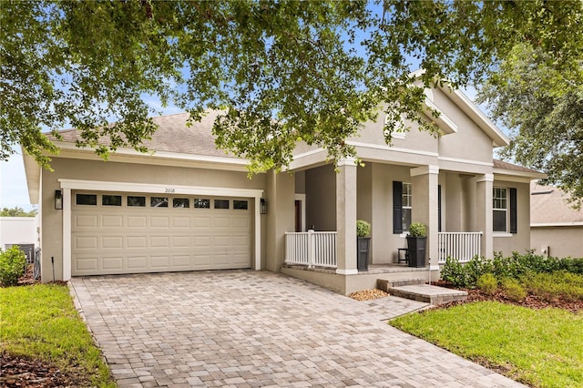 2018 Bay Clover Dr, Winter Garden, FL 34787 - view of front facade featuring covered porch, decorative driveway, stucco siding, a garage, and a shingled roof