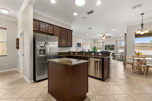 2018 Bay Clover Dr, Winter Garden, FL 34787 - kitchen with appliances with stainless steel finishes, dark brown cabinetry, light tile patterned flooring, open floor plan, and recessed lighting