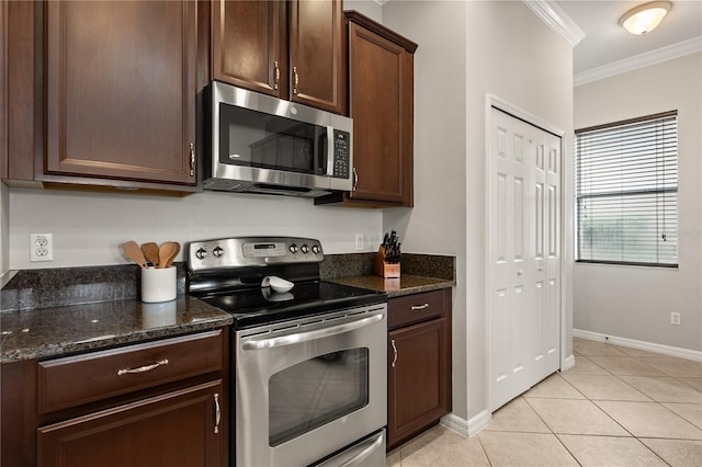 2018 Bay Clover Dr, Winter Garden, FL 34787 - kitchen featuring appliances with stainless steel finishes, ornamental molding, light tile patterned floors, dark brown cabinets, and dark stone countertops