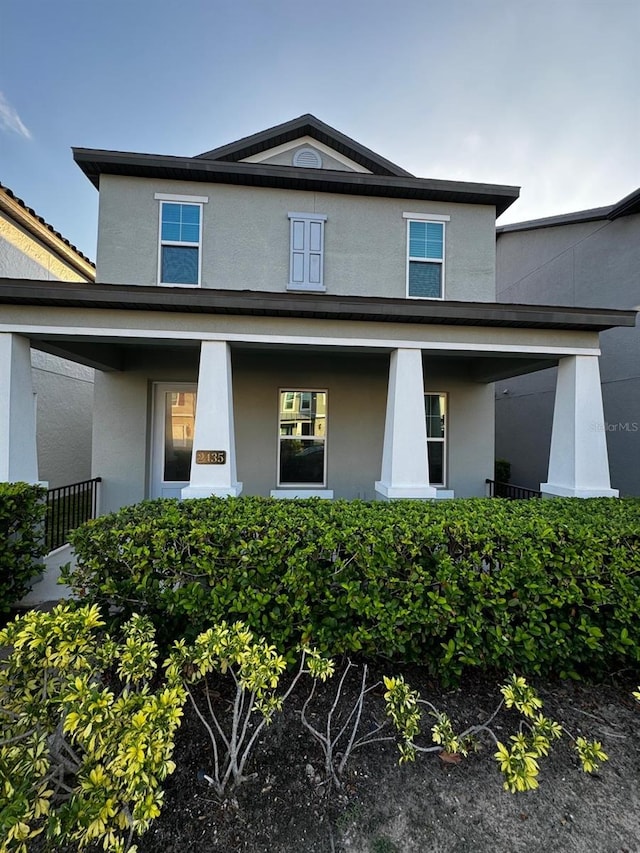 2435 Standing Rock Cir, Oakland, FL 34787 - view of front of house with stucco siding and a porch