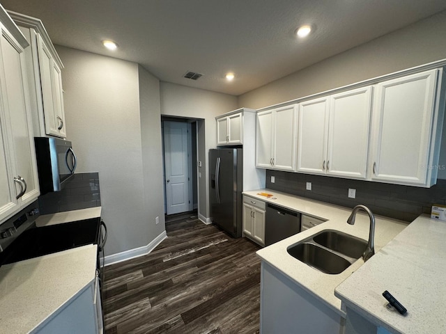 2435 Standing Rock Cir, Oakland, FL 34787 - kitchen with black microwave, stainless steel fridge with ice dispenser, dishwashing machine, dark wood-type flooring, and range with electric stovetop