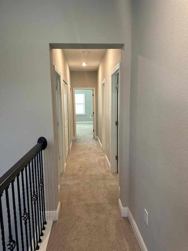 2435 Standing Rock Cir, Oakland, FL 34787 - corridor featuring light carpet and an upstairs landing