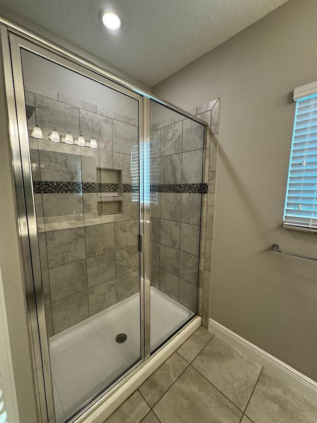 2435 Standing Rock Cir, Oakland, FL 34787 - bathroom featuring a stall shower, tile patterned floors, and a textured ceiling