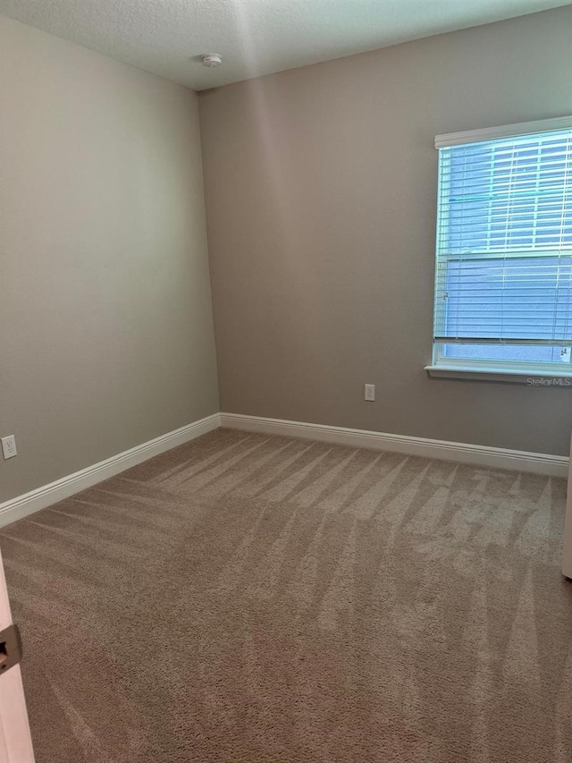 2435 Standing Rock Cir, Oakland, FL 34787 - carpeted spare room with baseboards