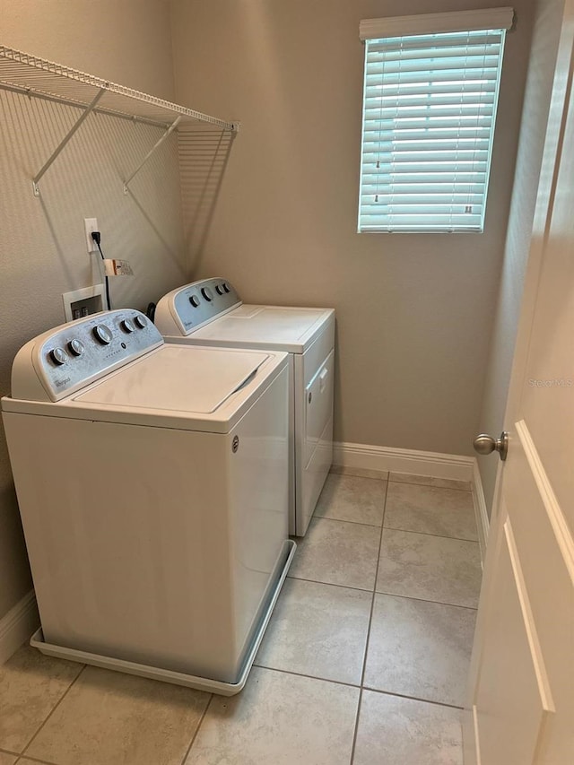 2435 Standing Rock Cir, Oakland, FL 34787 - laundry area featuring washing machine and dryer and light tile patterned flooring