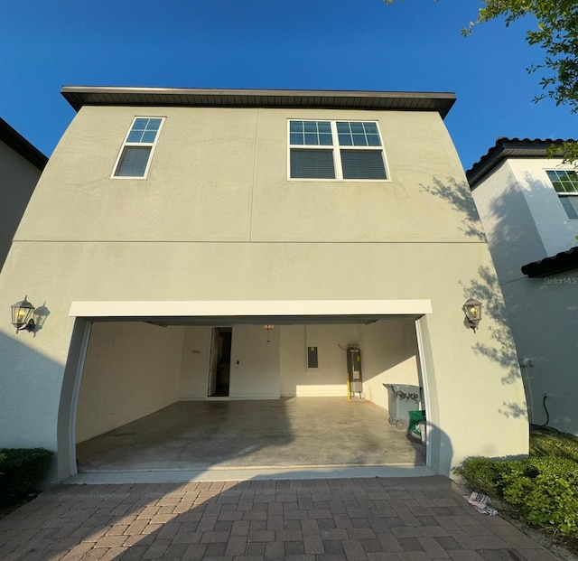 2435 Standing Rock Cir, Oakland, FL 34787 - view of front of house with stucco siding, driveway, electric panel, and a garage