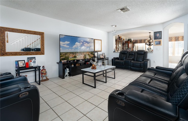 1208 Sandestin Way, Orlando, FL 32824 - living room with arched walkways, a chandelier, light tile patterned floors, and a textured ceiling