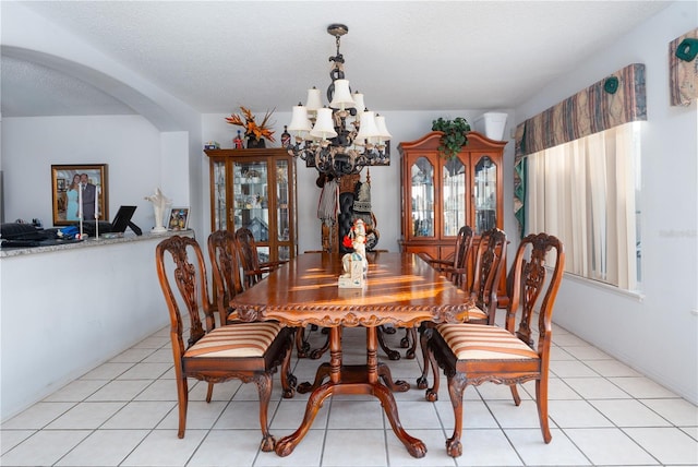 1208 Sandestin Way, Orlando, FL 32824 - dining area with a chandelier, arched walkways, and light tile patterned flooring