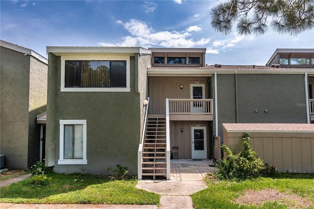 6019 Windhover Dr Unit C10-2, Orlando, FL 32819 - mid-century home with stairway and stucco siding