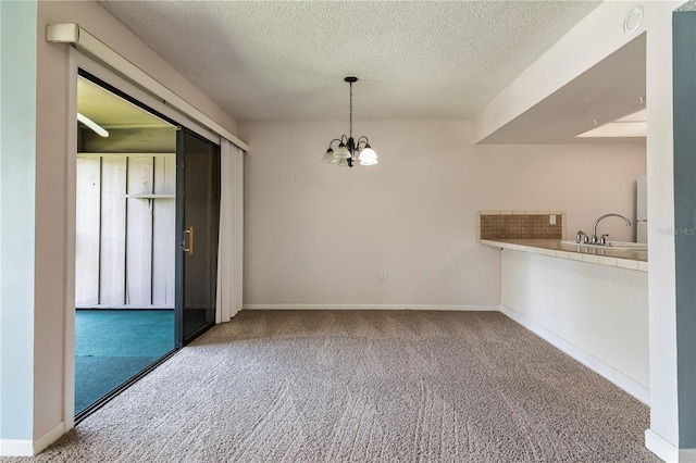 6019 Windhover Dr Unit C10-2, Orlando, FL 32819 - unfurnished dining area featuring carpet, a chandelier, and a textured ceiling