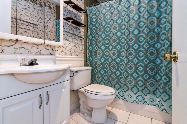 6019 Windhover Dr Unit C10-2, Orlando, FL 32819 - bathroom with wallpapered walls, vanity, tile patterned flooring, and wainscoting
