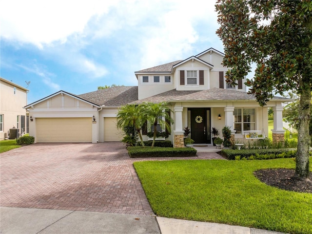 13235 Vennetta Way, Windermere, FL 34786 - view of front of home with decorative driveway, stucco siding, a garage, a front yard, and roof with shingles