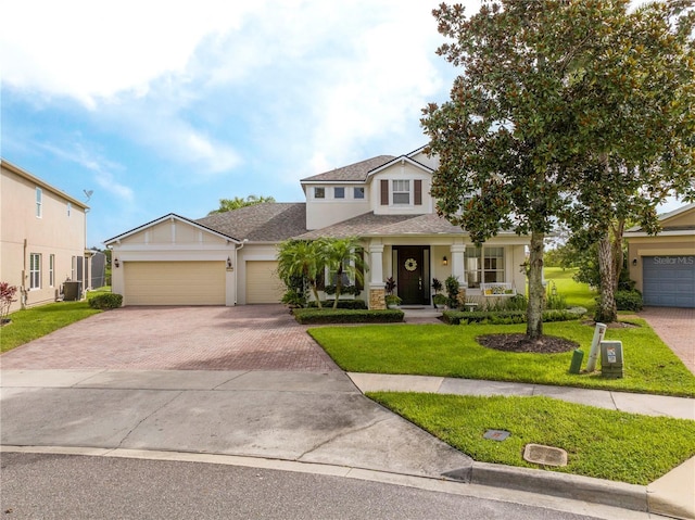 13235 Vennetta Way, Windermere, FL 34786 - view of front facade with decorative driveway, a front yard, roof with shingles, a garage, and stucco siding