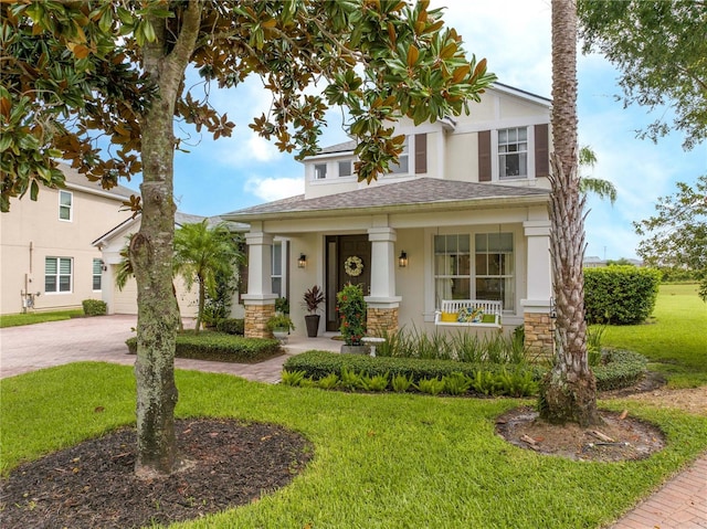 13235 Vennetta Way, Windermere, FL 34786 - view of front of property featuring stone siding, stucco siding, a porch, a shingled roof, and driveway