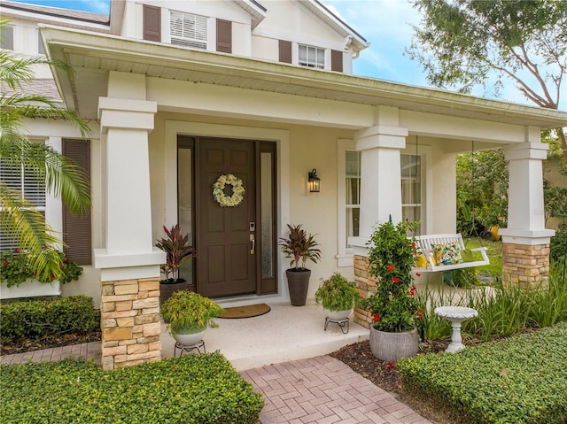 13235 Vennetta Way, Windermere, FL 34786 - doorway to property featuring covered porch and stucco siding