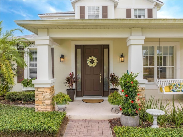 13235 Vennetta Way, Windermere, FL 34786 - view of exterior entry with covered porch and stucco siding