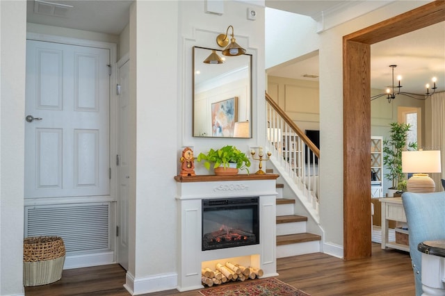 13235 Vennetta Way, Windermere, FL 34786 - stairs featuring wood finished floors, a glass covered fireplace, and a chandelier