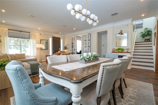 13235 Vennetta Way, Windermere, FL 34786 - dining space with wood finished floors, ornamental molding, recessed lighting, and stairs
