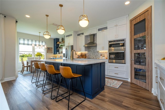 13235 Vennetta Way, Windermere, FL 34786 - kitchen featuring stainless steel appliances, tasteful backsplash, white cabinetry, dark wood finished floors, and light countertops