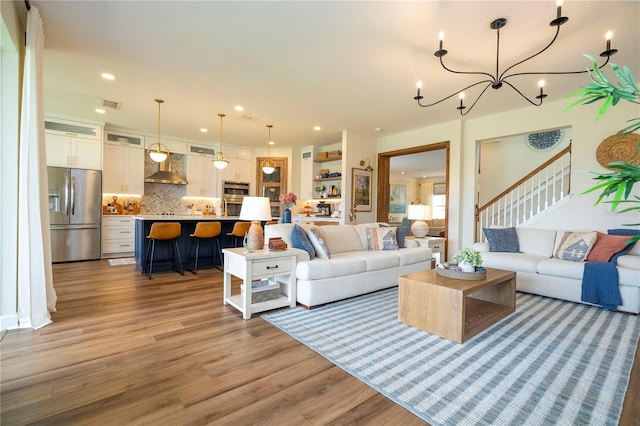 13235 Vennetta Way, Windermere, FL 34786 - living area featuring light wood-type flooring, a chandelier, stairs, and recessed lighting