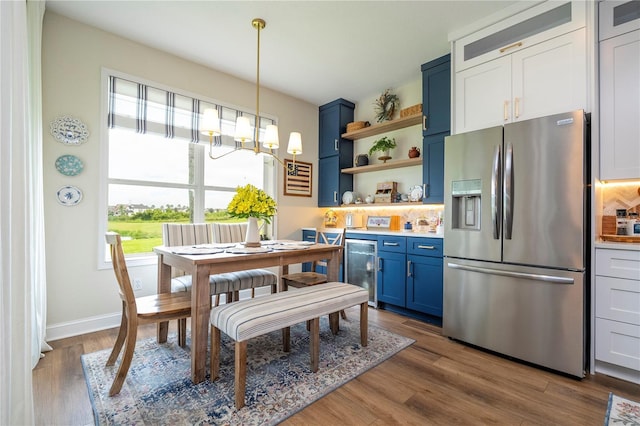 13235 Vennetta Way, Windermere, FL 34786 - kitchen featuring blue cabinets, stainless steel fridge with ice dispenser, open shelves, beverage cooler, and a chandelier