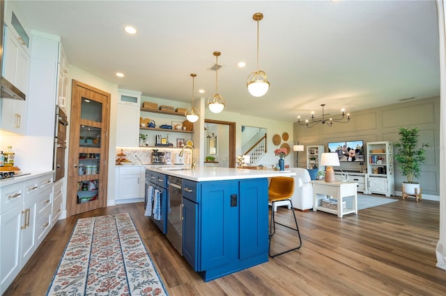13235 Vennetta Way, Windermere, FL 34786 - kitchen with blue cabinetry, open shelves, white cabinetry, light countertops, and dark wood-style floors