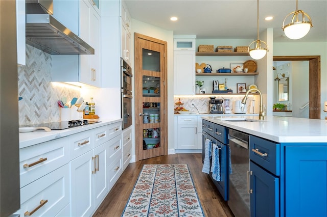 13235 Vennetta Way, Windermere, FL 34786 - kitchen with blue cabinetry, wall chimney range hood, white cabinets, light countertops, and open shelves