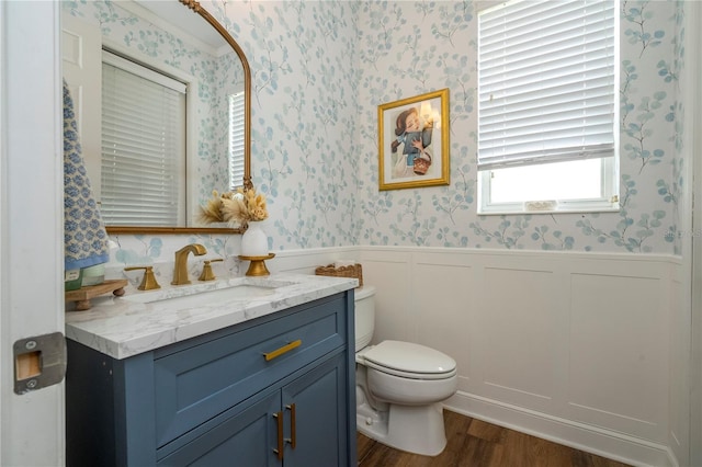 13235 Vennetta Way, Windermere, FL 34786 - bathroom featuring wallpapered walls, wood finished floors, vanity, and wainscoting