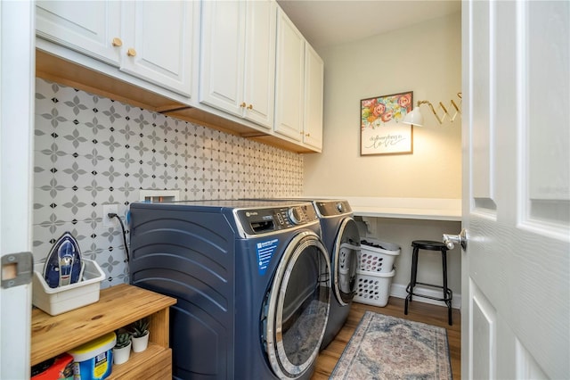 13235 Vennetta Way, Windermere, FL 34786 - laundry area featuring cabinet space, washer and clothes dryer, and wood finished floors